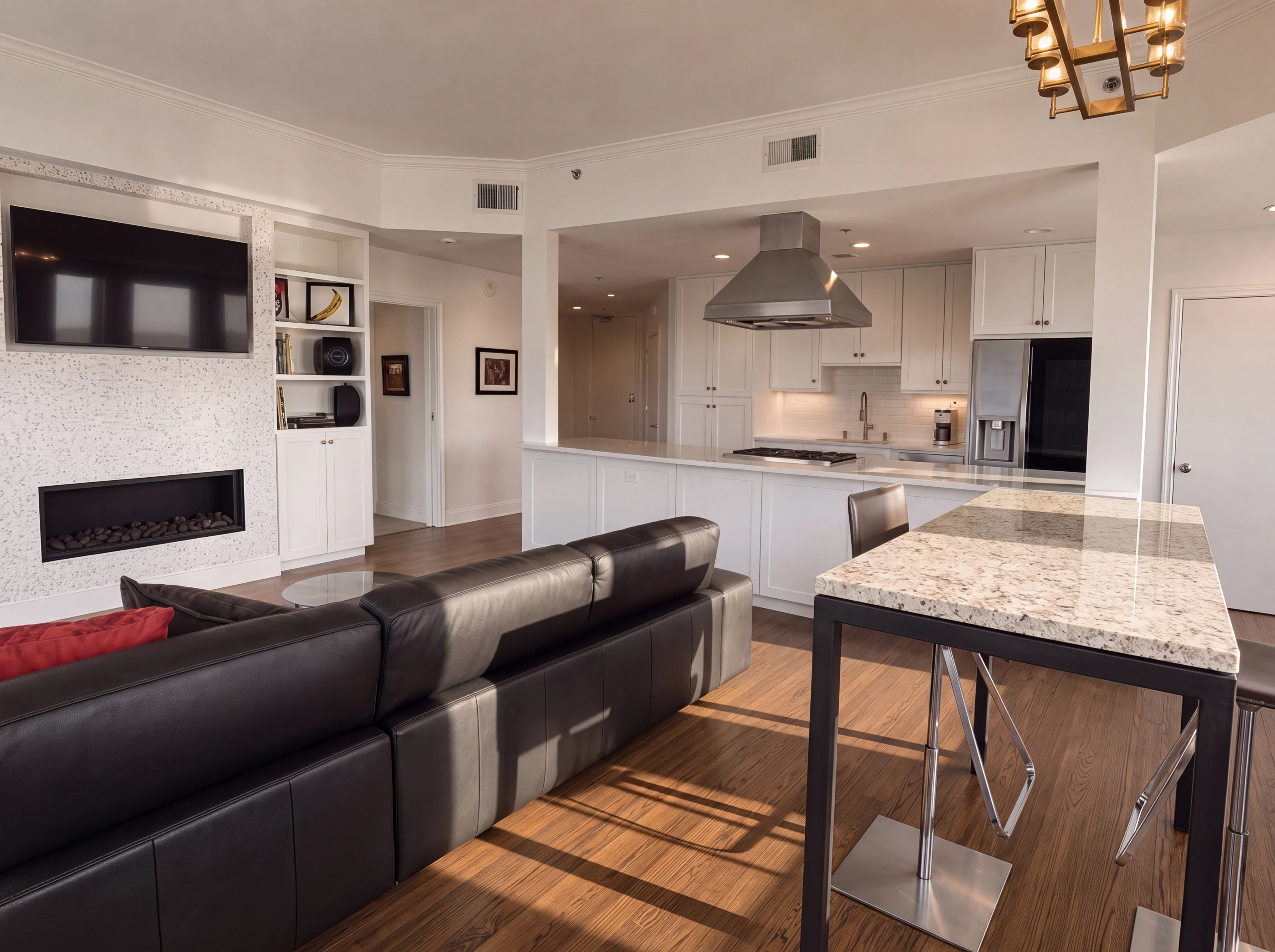 Living room and kitchen with the fireplace wall